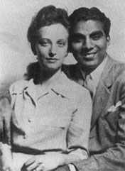 Cheddi and Janet Jagan dressed formally and smiling in their 1943 wedding 
photo.