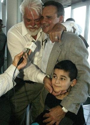JOY: Reynol Rodriguez, left, greets the returning Pedro Remon, who was also met by son Peter, 7. Nearly four years after being arrested in Panama on accusations of plotting to kill Fidel Castro, three Cuban exiles from Miami-Dade, including Remon, return home. RAUL RUBIERA/HERALD STAFF
