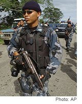 [Venezuelan police officers, right, arrive at a British-owned cattle ranch this month to determine whether land will be turned over to squatters.]