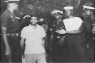 Young Guyanese men being detained by police officers
